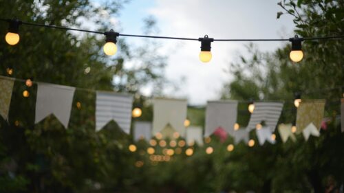 Festive Garden Party Lights with Hanging Bunting Flags 4K Wallpaper