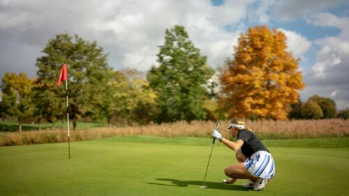 Professional Female Golfer Reading the Green Desktop Wallpaper