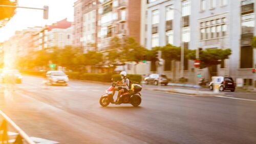 Scooter Rider in Golden Hour City Street Desktop Wallpaper
