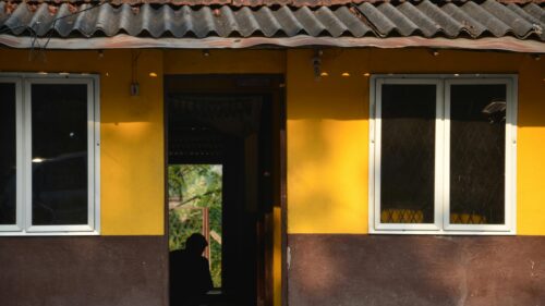 Silhouette in a Yellow Country House Doorway 4K Desktop Wallpaper