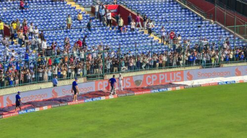 Exciting Cricket Stadium Atmosphere with Fans and Players 4K Wallpaper