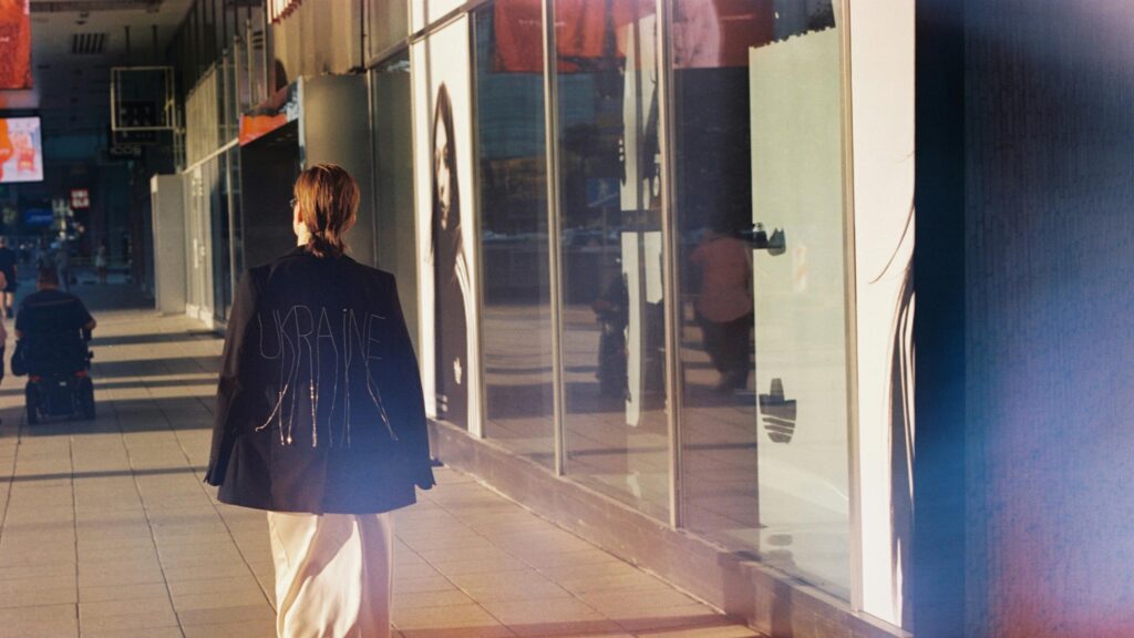 Stylish Person Walking in Urban City Street Desktop Wallpaper