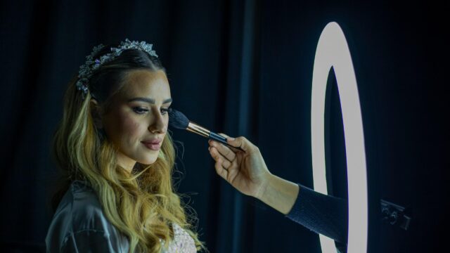 Professional Makeup Artist Applying Powder to Beautiful Bride Desktop Wallpaper