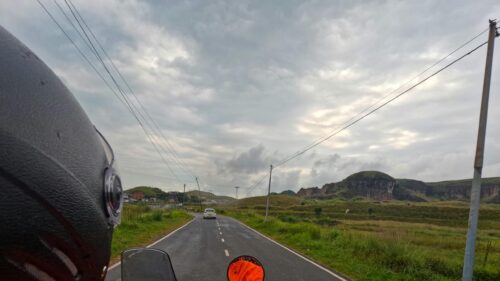 Scenic Country Road Drive Under Moody Cloudy Skies Desktop Wallpaper