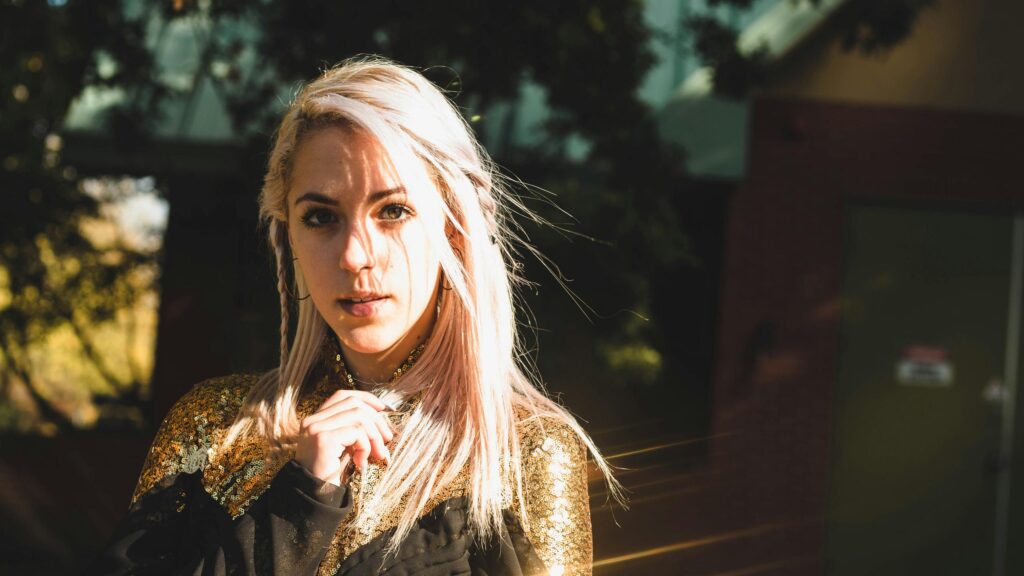 Beautiful Blonde Girl in Golden Sequin Outfit 4K Desktop Wallpaper