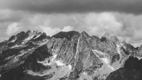 Dramatic Alpine Mountain Peaks Under Stormy Sky Desktop Wallpaper
