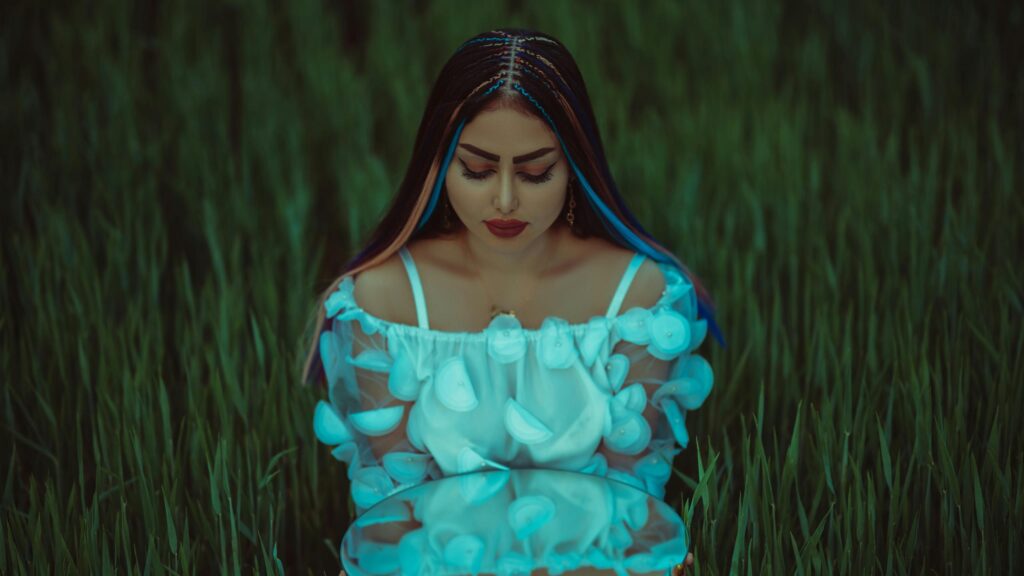 Dreamy Woman Holding Mirror in Lush Green Field 4K Wallpaper
