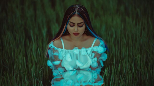 Dreamy Woman Holding Mirror in Lush Green Field 4K Wallpaper