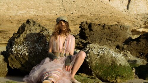 Woman in Ethereal Striped Dress on Coastal Rocks 4K Desktop Wallpaper
