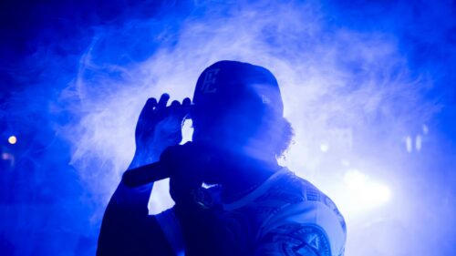 Rapper Performing on Stage with Blue Fog Light 4K Wallpaper