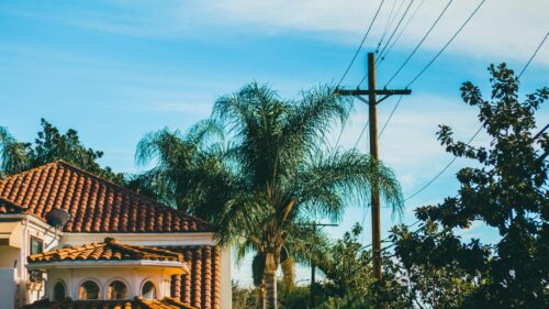 Sunny Suburban California House with Palm Tree and Power Lines 4K Wallpaper
