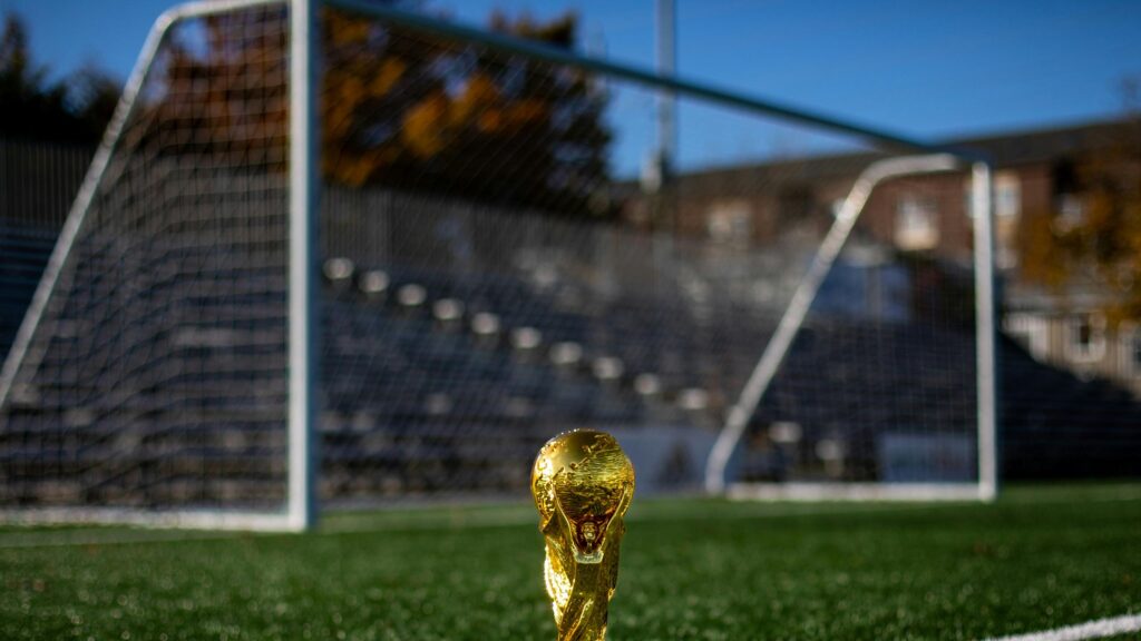 Golden World Cup Trophy on Soccer Pitch 4K Wallpaper
