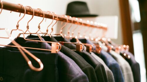 Elegant Copper Clothes Hangers with Suits on Rack 4K Desktop Wallpaper