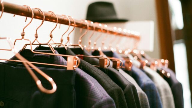 Elegant Copper Clothes Hangers with Suits on Rack 4K Desktop Wallpaper