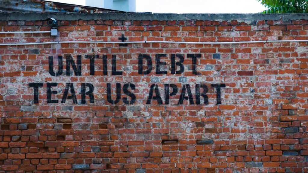 Until Debt Tear Us Apart Stencil Graffiti Red Brick Wall 4K Wallpaper