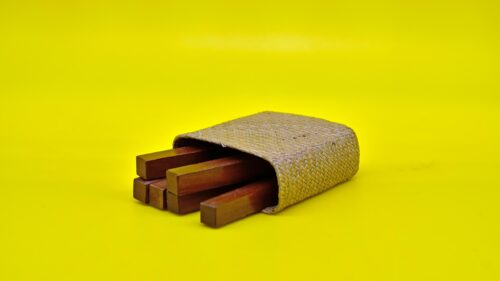 Minimalist Wooden Sticks in Woven Case on Bright Yellow 4K Wallpaper
