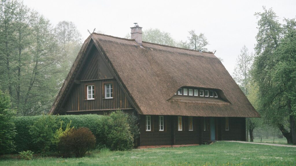 Rustic Thatched Roof Cottage in Misty Forest 4K Desktop Wallpaper