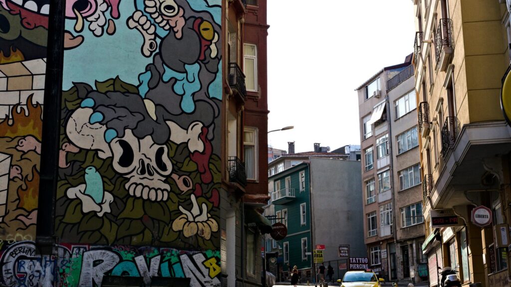 Urban Street Art Mural with Skull and Graffiti Desktop Wallpaper