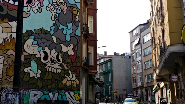 Urban Street Art Mural with Skull and Graffiti Desktop Wallpaper