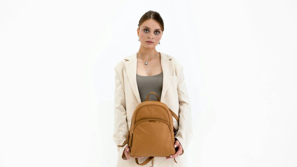 Elegant Woman Holding Leather Backpack Fashionable Desktop Wallpaper