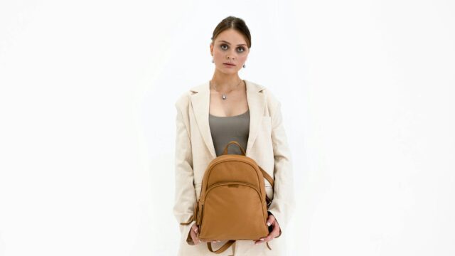 Elegant Woman Holding Leather Backpack Fashionable Desktop Wallpaper