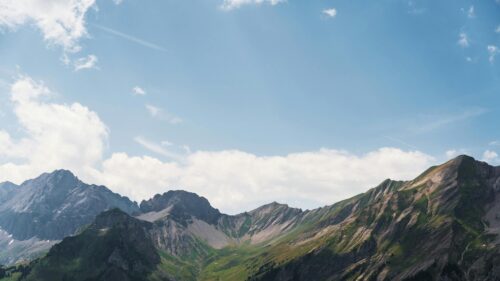 Stunning Alpine Mountain Range Under Blue Sky 4K Wallpaper