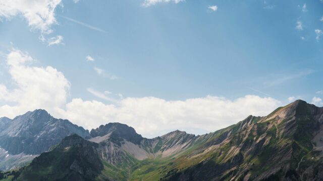 Stunning Alpine Mountain Range Under Blue Sky 4K Wallpaper