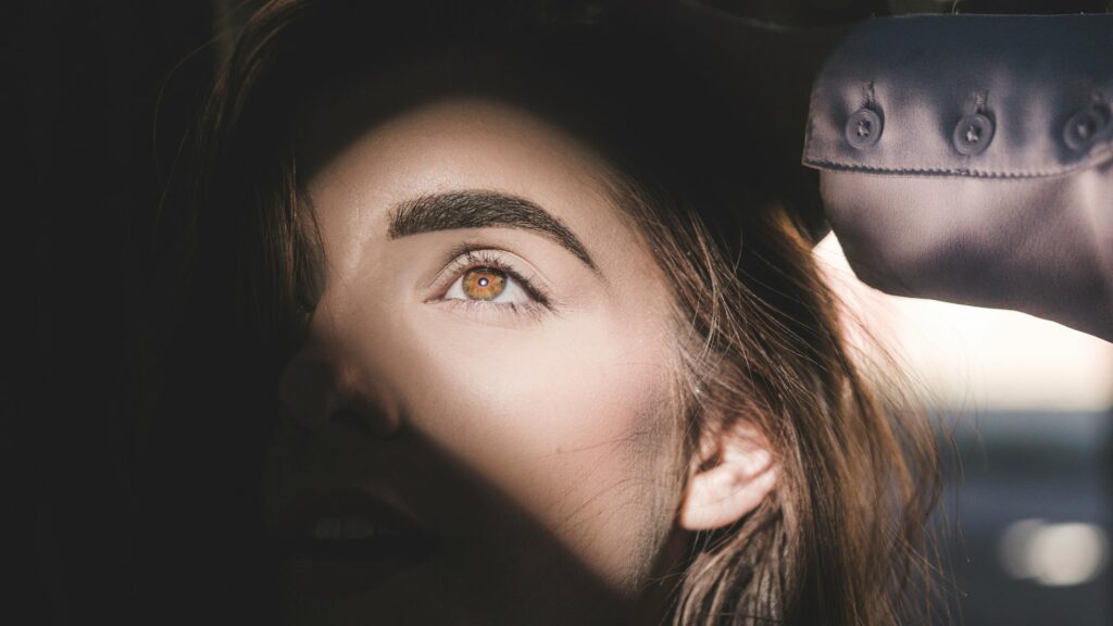 Stunning Close-Up Portrait of a Woman with Hazel Eyes 4K Wallpaper
