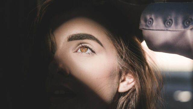 Stunning Close-Up Portrait of a Woman with Hazel Eyes 4K Wallpaper