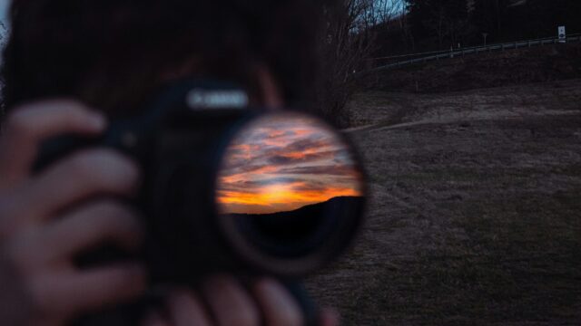 Stunning Sunset Reflection in Camera Lens 4K Desktop Wallpaper