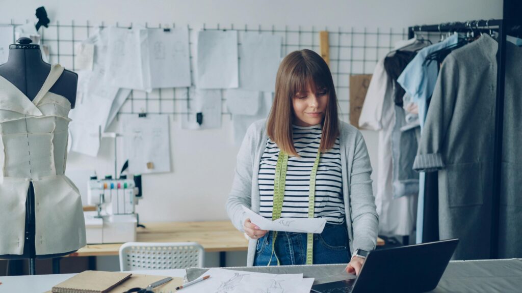 Professional Fashion Designer Working in Studio Desktop Wallpaper