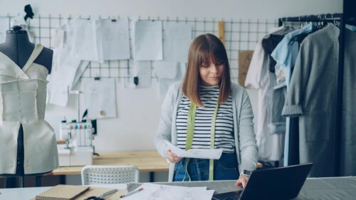 Professional Fashion Designer Working in Studio Desktop Wallpaper