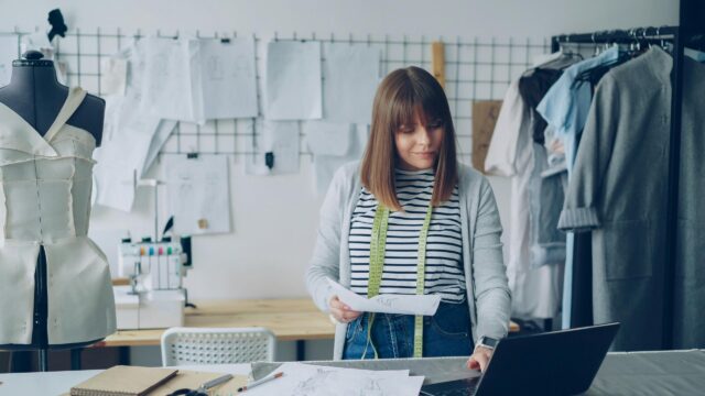 Professional Fashion Designer Working in Studio Desktop Wallpaper
