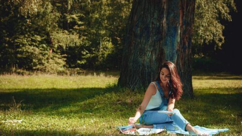 Woman Painting on Canvas Under a Forest Tree Desktop Wallpaper
