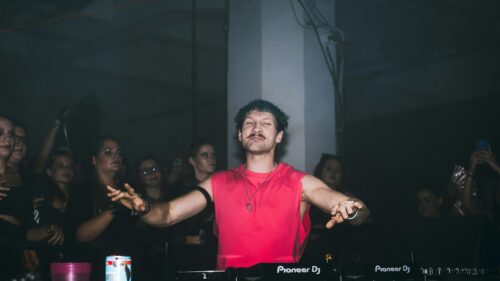 Energetic DJ Performing at Live Nightclub Event 4K Wallpaper