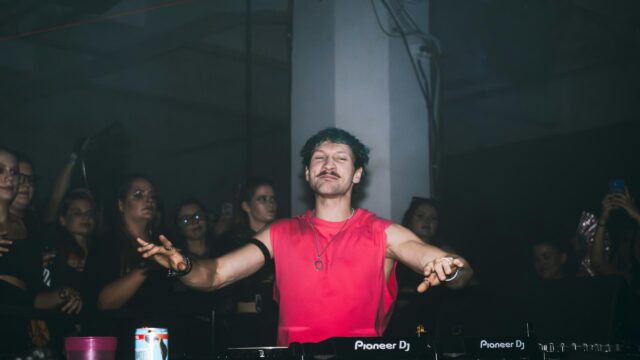 Energetic DJ Performing at Live Nightclub Event 4K Wallpaper