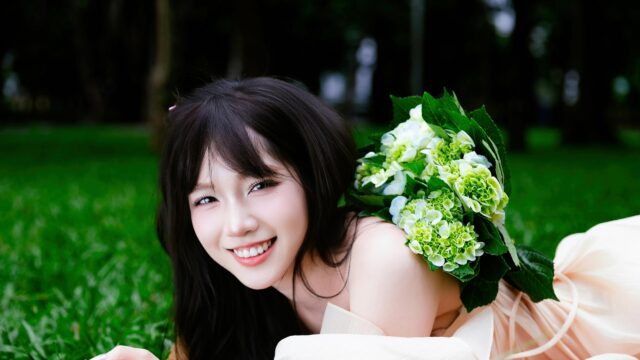 Beautiful Asian Girl Lying on Grass with Hydrangea Flowers 4K Wallpaper