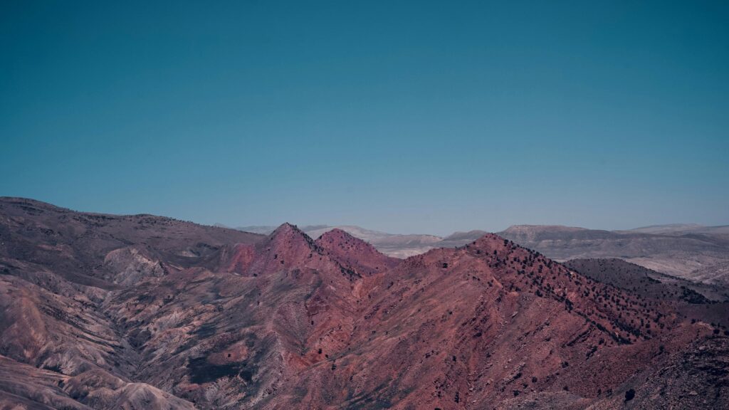 Rugged Red Desert Mountains Under Clear Blue Sky 4K Wallpaper