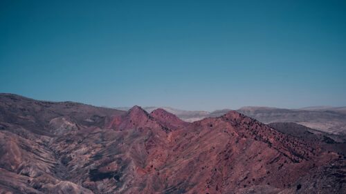 Rugged Red Desert Mountains Under Clear Blue Sky 4K Wallpaper