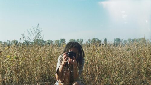 Woman Photographer Taking Pictures in an Autumn Field Desktop Wallpaper