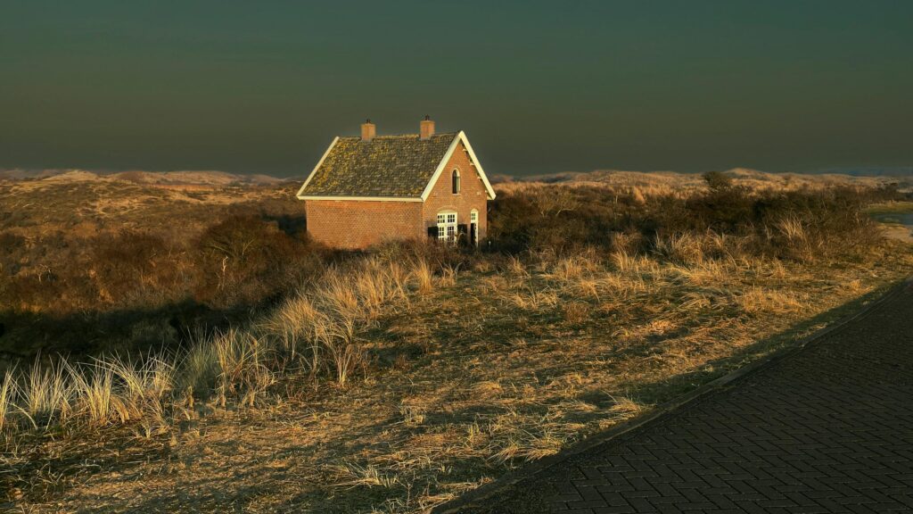 Brick House in Scenic Coastal Dunes Landscape 4K Wallpaper