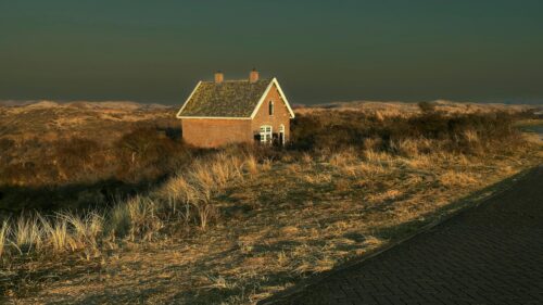 Brick House in Scenic Coastal Dunes Landscape 4K Wallpaper