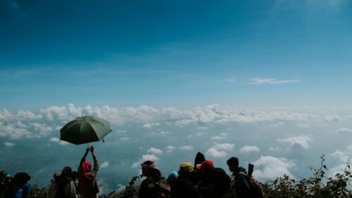 Hikers Above the Clouds Scenic Mountain Adventure Desktop Wallpaper