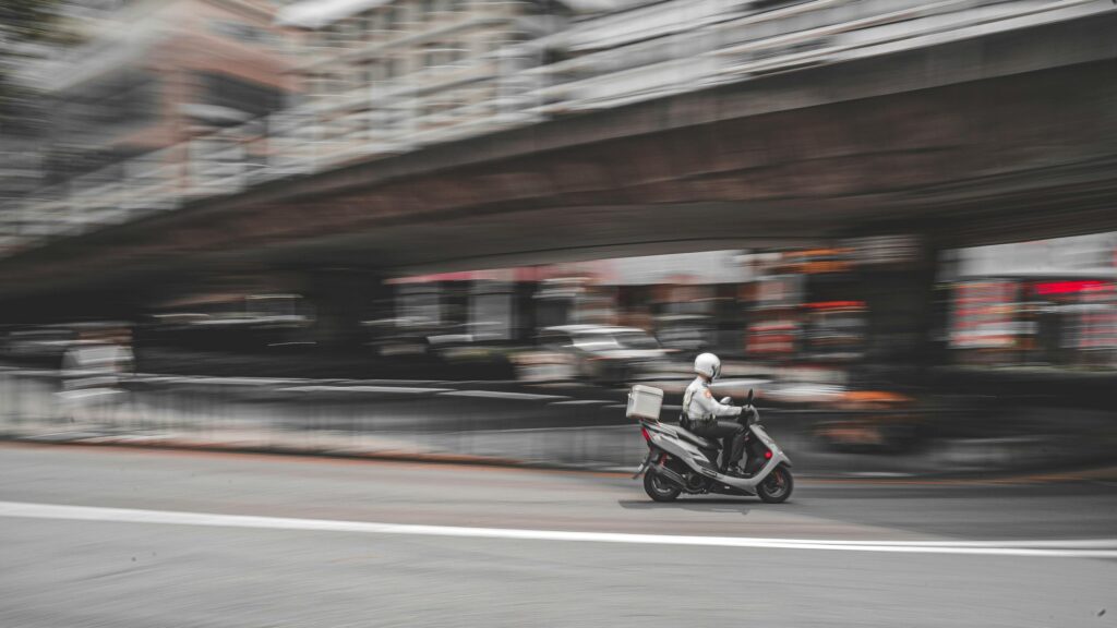 Speeding Delivery Scooter Urban Motion Blur PC Wallpaper