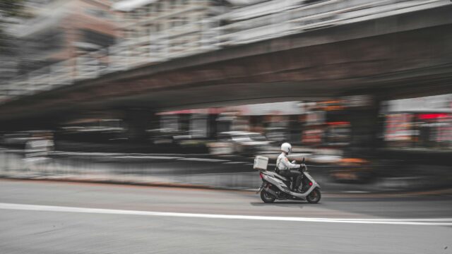 Speeding Delivery Scooter Urban Motion Blur PC Wallpaper