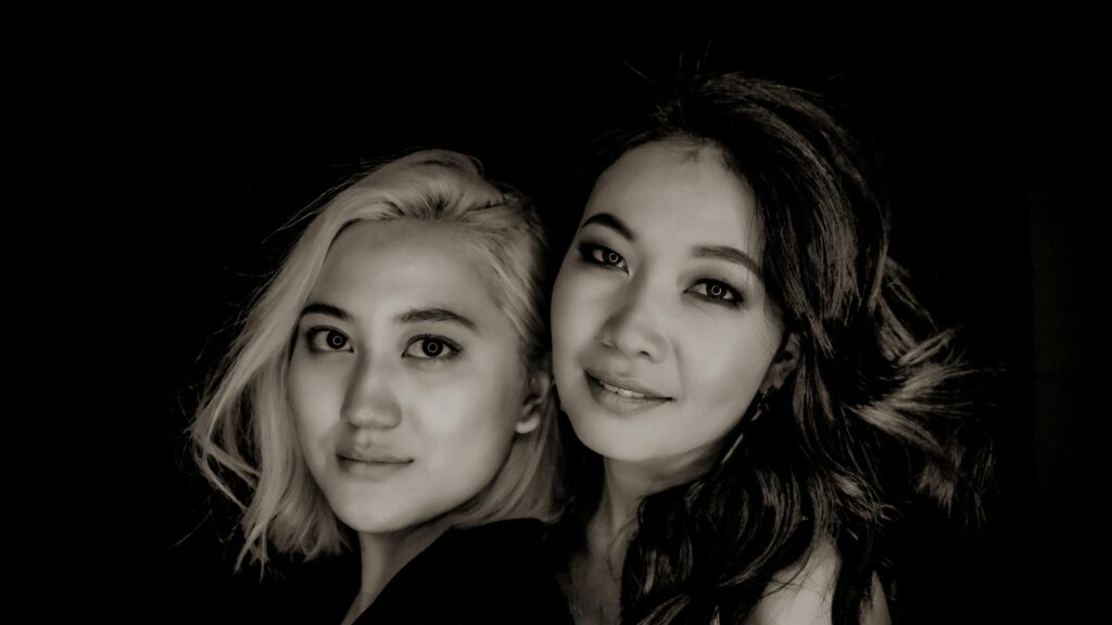 Two Elegant Women Black and White Portrait 4K Wallpaper