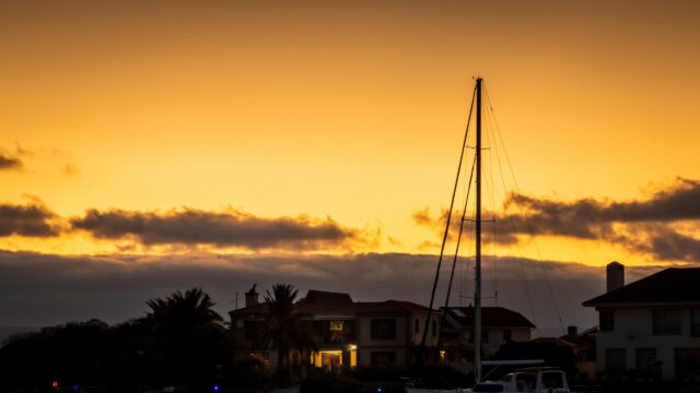 Stunning Coastal Sunset With Yacht Silhouette 4K Wallpaper