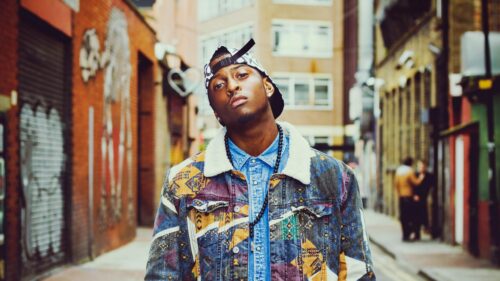 Young Man in Stylish Patterned Jacket Urban Street 4K Desktop Wallpaper