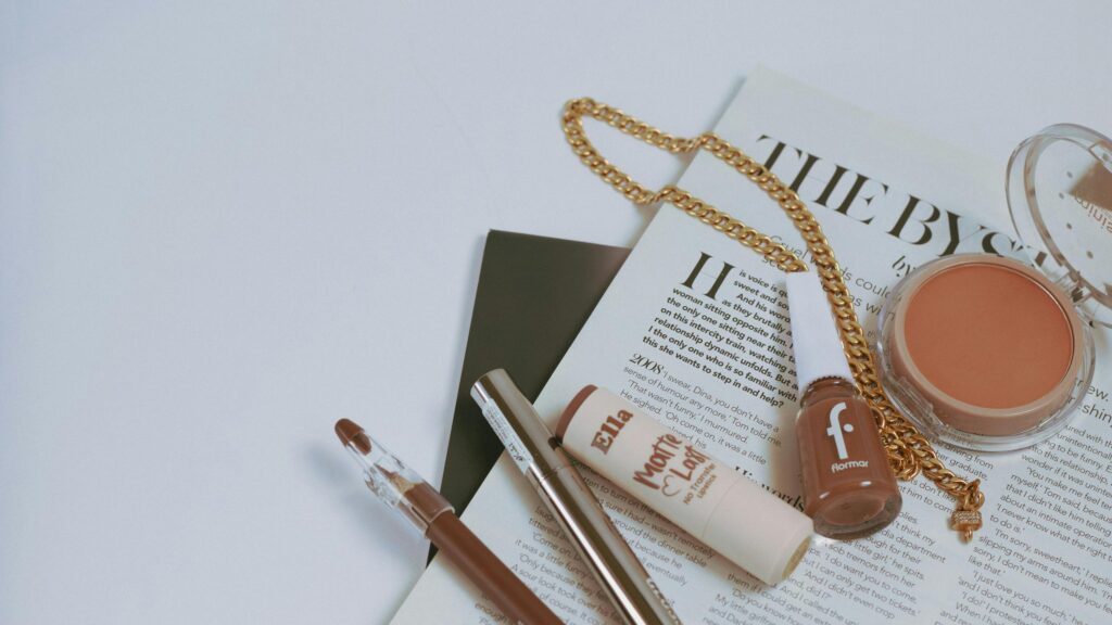 Elegant Makeup Flat Lay with Cosmetics and Gold Chain 4K Desktop Wallpaper