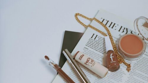 Elegant Makeup Flat Lay with Cosmetics and Gold Chain 4K Desktop Wallpaper